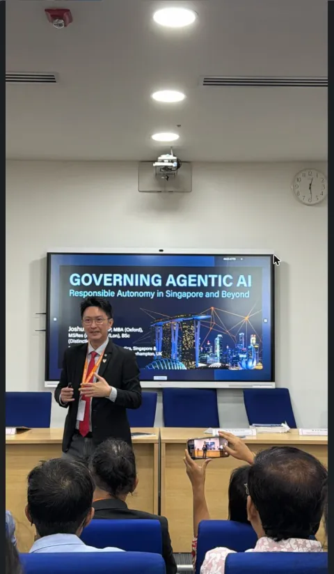 Dr. Joshua Lau speaking on stage