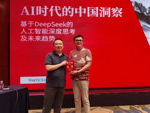 Michael Low speaking on stage
