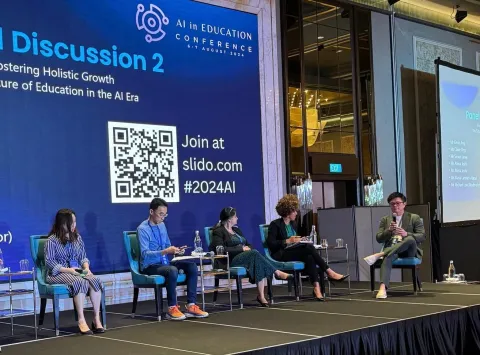 Michael Low speaking on stage
