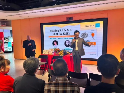 Michael Low speaking on stage