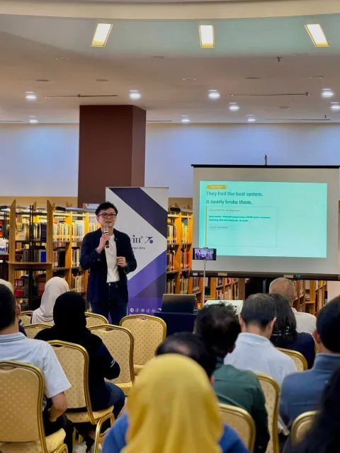 Michael Low speaking on stage