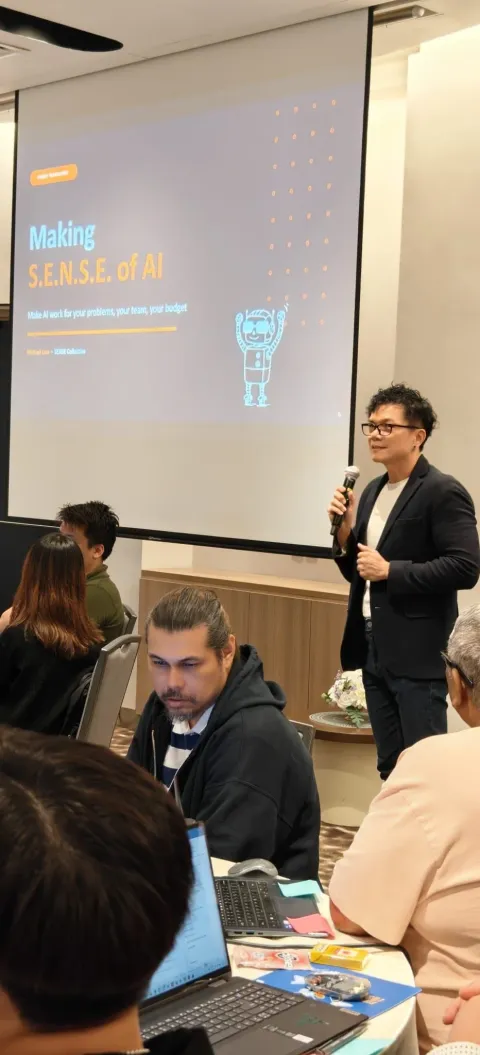Michael Low speaking on stage