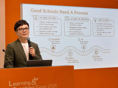 Michael Low speaking on stage