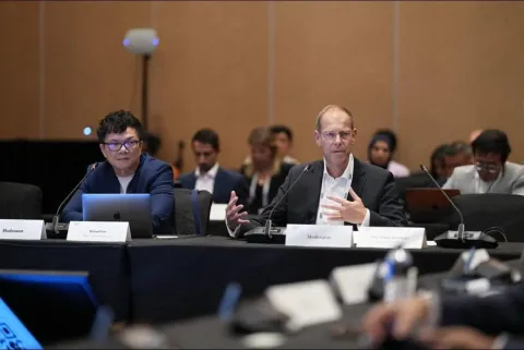 Michael Low speaking on stage