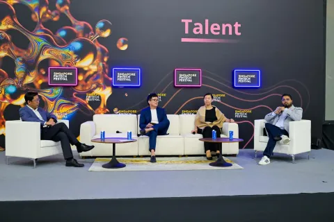 Michael Low speaking on stage
