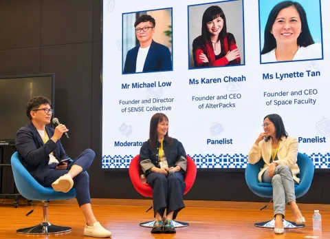 Michael Low speaking on stage