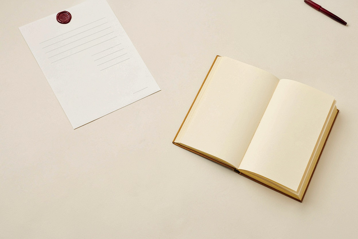 A sealed briefing sheet and a bound workbook on a desk, representing the two programme formats.